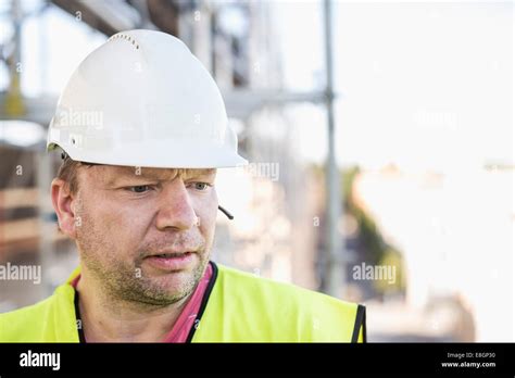 Construction Worker Wearing Hardhat At Construction Site Stock Photo