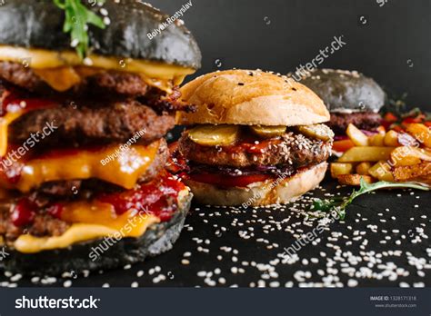 Many Different Burgers Ingredients On Black Stock Photo 1328171318