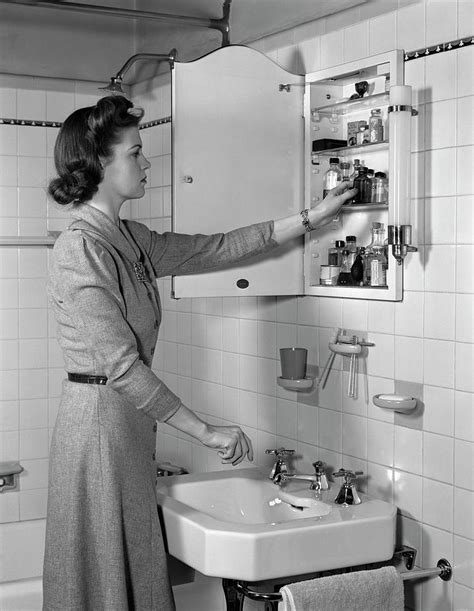 1940s Woman Reaching Into Bathroom Photograph By Vintage Images Pixels