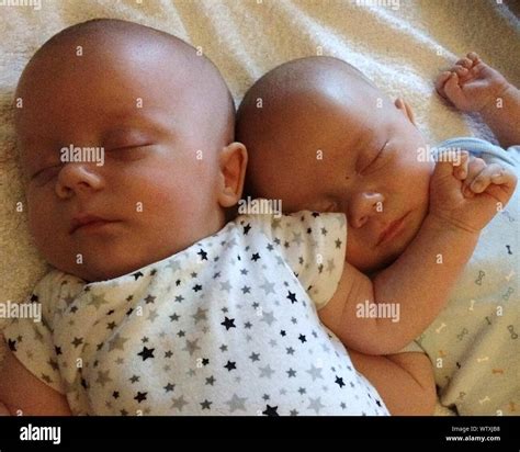 Close Up Of Cute Twin Babies Sleeping On Bed Stock Photo Alamy