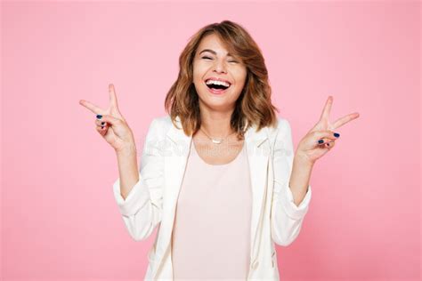 Portrait Of A Cheerful Happy Girl Showing Peace Gesture Stock Image
