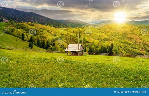 Hay Shed On A Grassy Field In Mountains At Sunset Stock Photo Image
