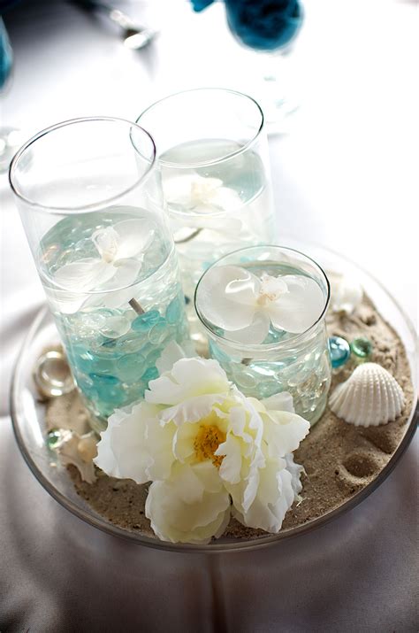 Transport yourself to sun and fun with the ultimate collection of beach party tableware and party supplies from oriental trading. Beach centerpiece made with cylinder vases in sand and ...