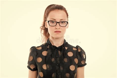 female in red smart casual suit wearing face mask of black color and reading something on her