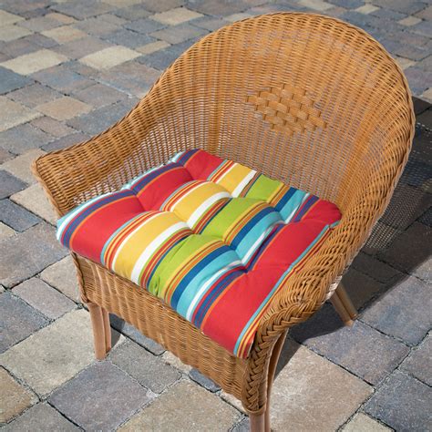 A Wicker Chair With Colorful Striped Cushions On The Seat And Back