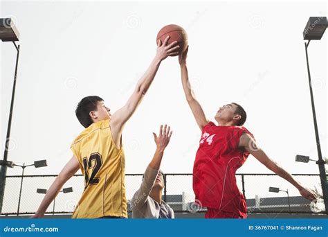 Basketball Players Fighting For A Ball Stock Image Image Of