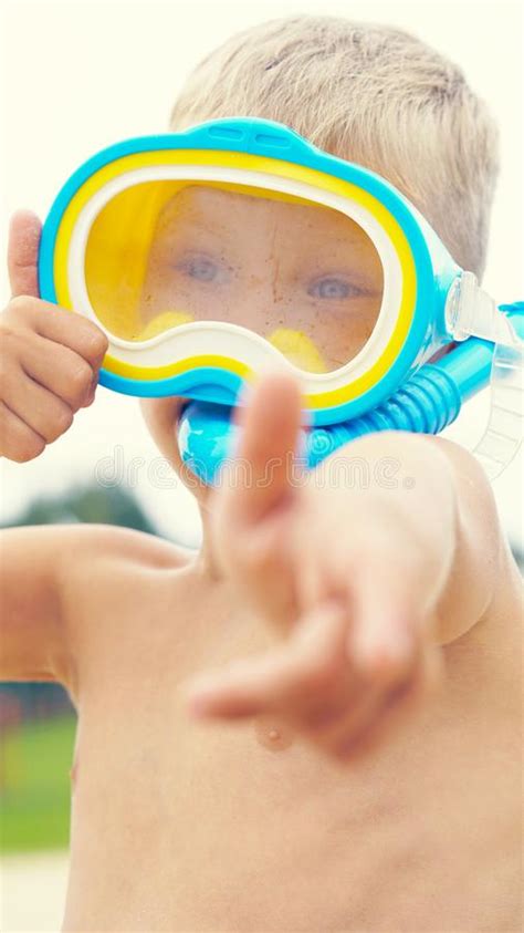 Little Boy With Snorkeling Equipment Lying On Tropical Beach And Posing