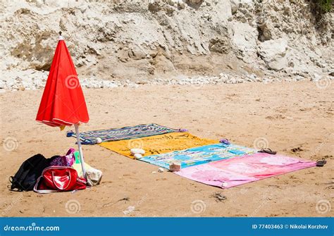 Beach Towels And Red Umbrella In The Sand Near The Sea Stock Image