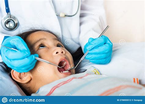 Doctor Examines Oral Cavity Of Little Child Uses Mouth Mirror To