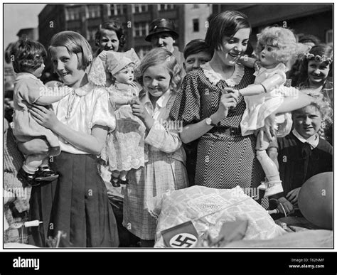 vintage nazi propaganda image of a group of german girls with their dolls and prams with