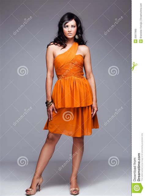 Elegant Woman In Orange Dress Full Body Shot Stock Photo