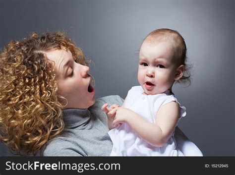 Curly Mother Holding Cute Upset Baby Free Stock Photos Stockfreeimages