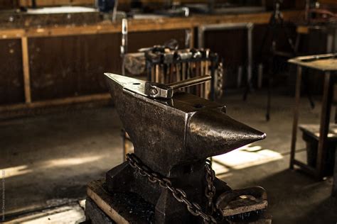 A Metal Anvil Sits In A Blacksmith Workshop With A Hammer On Top Del