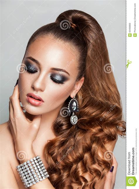 Beauty Brunette Fashion Model Girl With Long Healthy Curly Brown Hair Ponytail Stock Photo