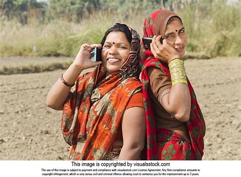 Indian Rural Women Sister Together Talking On Mobile Phone Farm