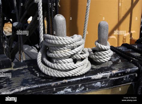 Ropes Wrapped Around Belaying Pins On Board A Sailing Ship Stock Photo