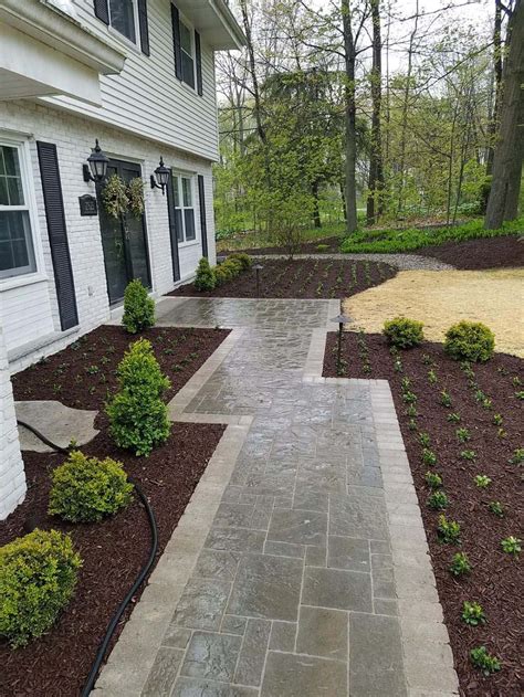 Concrete pavers can mimic the look of brick but are manufactured and produced in molds, resulting in a uniform look in size and color. two-tone-paver-walkway - Best Choice Landscape