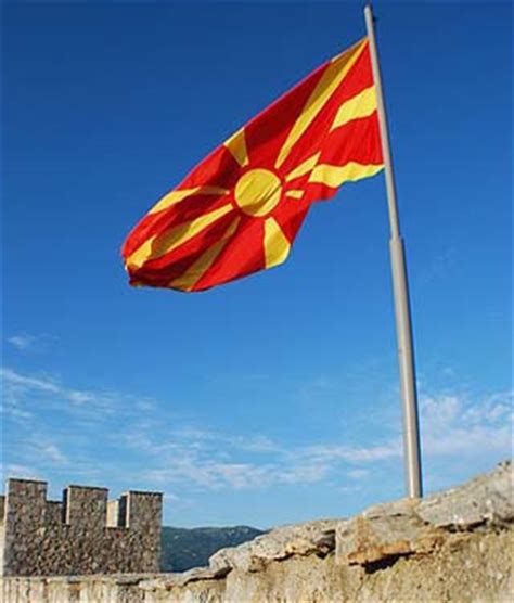 National flag consisting of a red field with a golden central disk and golden rays extending to the flag edges. Macedonia Flags and Symbols and National Anthem