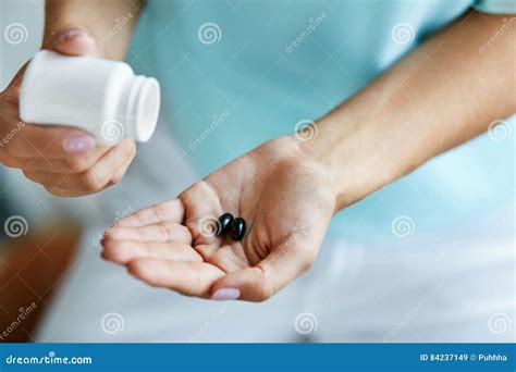 Medicine Closeup Of Female Hand Pouring Pills Into Palm Stock Image