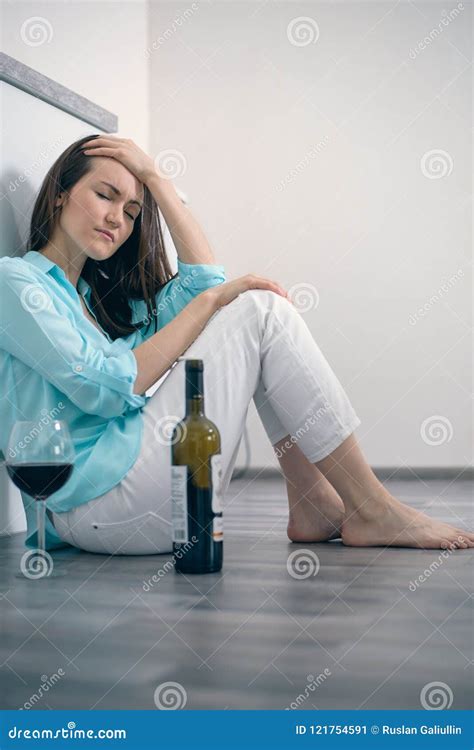 Young Woman Sitting On The Floor Drinking Wine Alcoholism Depression Divorce Stock Image