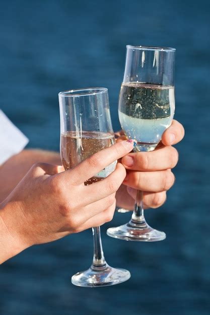 Premium Photo Man And Woman Hands Are Holding Champagne Glasses