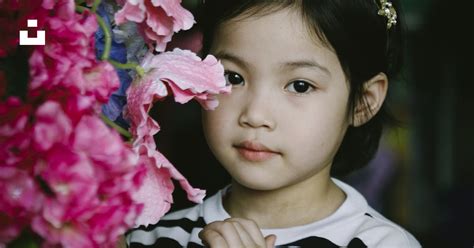 Selective Focus Photography Of Girl Beside Pink Petaled Flowers Photo
