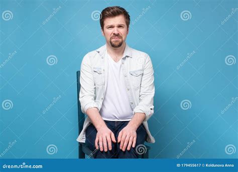 Thoughtful Stressed Young Man On A Chair Sitting Alone Stock Image