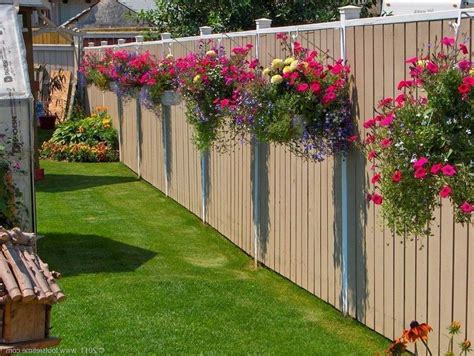 A Wooden Fence With Flowers Growing On It