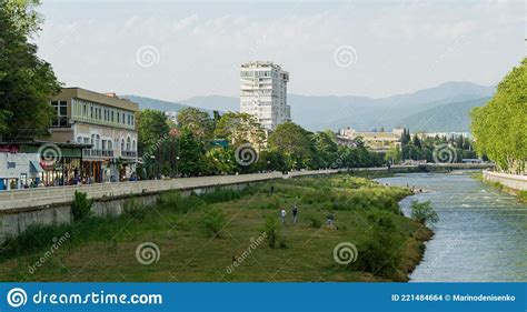 Beautiful Spring View Of Sochi River Embankment With Trees And Peaks