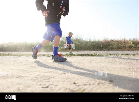 Two Boys Running Outdoors Stock Photo Alamy