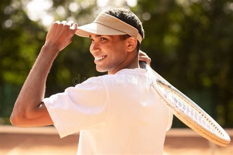 Man In Sun Visor At The Tennis Courts Before Workout Stock Photo