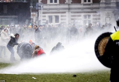 dutch police blast angry anti lockdown protestors with water cannon in amsterdam daily mail online