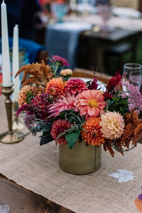 Autumn Centerpiece Full Of Dahlias And Persimmons In A Gold Cylinder