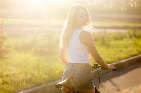 Blonde Girl Back Riding A Bike Photo Free Download
