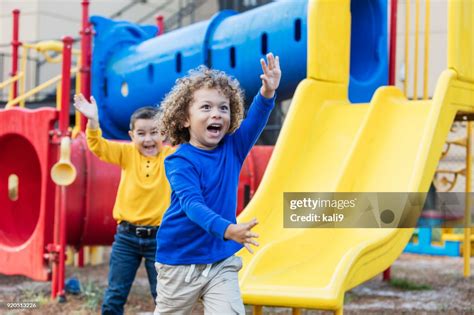 Two Multiethnic Boys Playing On Playground High Res Stock Photo Getty