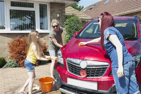 Lesbian Couple And Daughter Washing Car In Sunny Driveway — Female