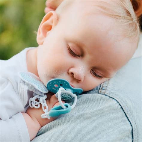 Baby Sleeps On His Mother S Shoulder In The Park Close Up Of A