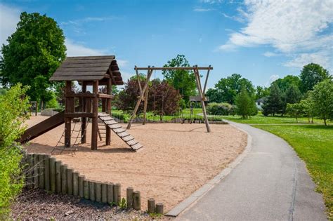 Children`s Playground Equipped With Wooden Swings And Slides Stock