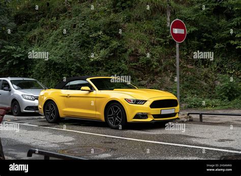 Yellow Car Is Parked At Asphalt Road In The City Stock Photo Alamy