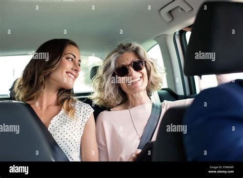 Two Women Chatting In Back Seat Of Car Stock Photo Alamy