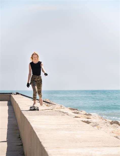 Premium Photo A Beautiful Blonde Girl On Skateboard In Summer Hot Day