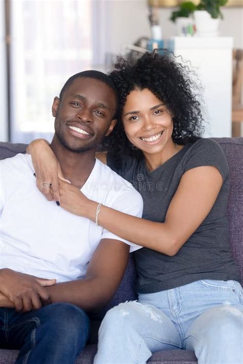 Portrait Of Happy Young Black Couple Posing Hugging At Couch Stock Image Image Of Living