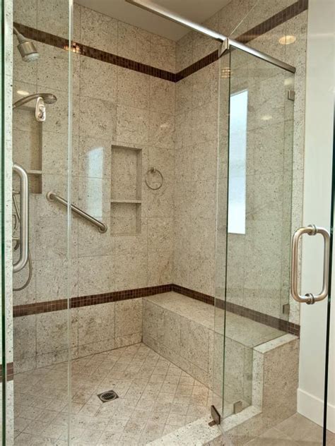 See This Modern Glass Shower With Granite Tile Equipped With Grab Bars And A Bench At
