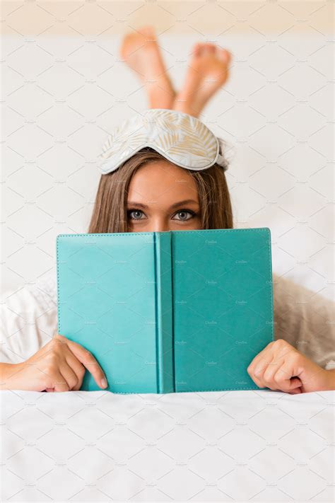 Young Woman Read Book In Bed High Quality Holiday Stock Photos