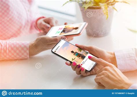 Two Women Using Their Mobile Phones Together Stock Image Image Of