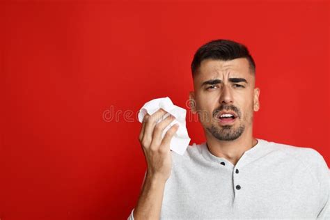 Man Sneezing On Background Space For Text Cold Symptoms Stock Photo