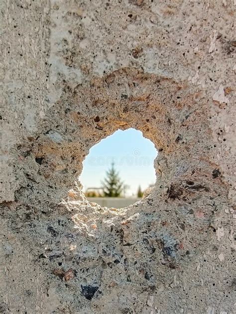 Bullet Hole In A Concrete Wall Close Up As A Result Of The Fighting
