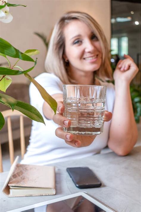 Young Woman Holds Out A Glass Of Water Healthy Food Concept Stock
