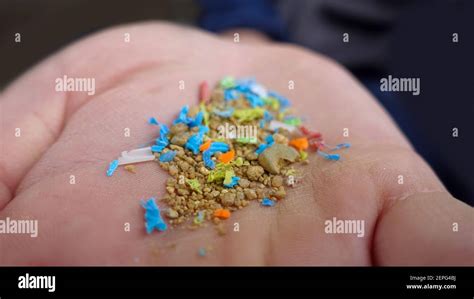 Side View Of A Person Holding Micro Plastics In His Hand Non