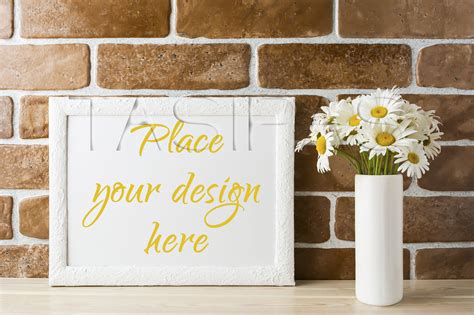 Download White landscape frame mockup with daisy bouquet in styled vase. By TasiPas | TheHungryJPEG.com